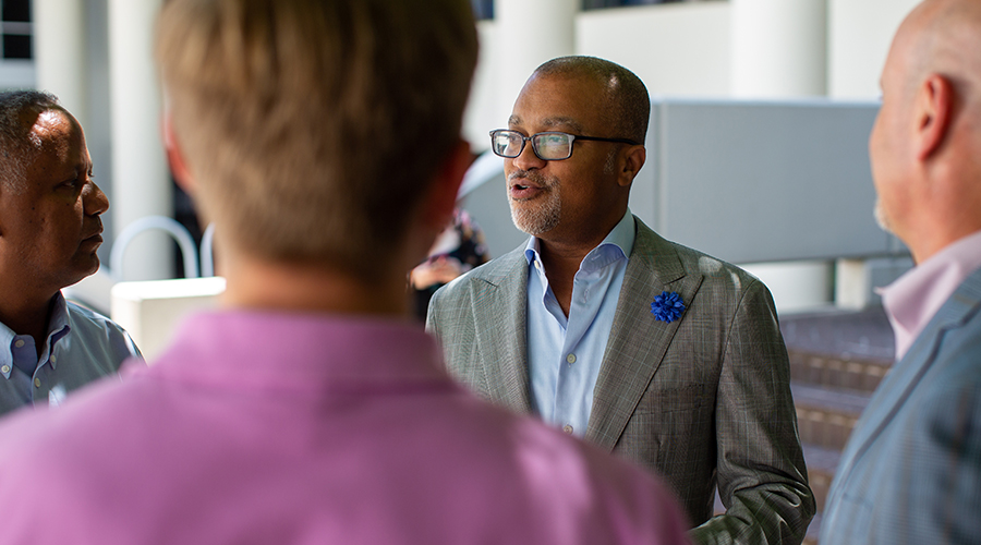Emory Law faculty member in conversation with colleagues at a university event